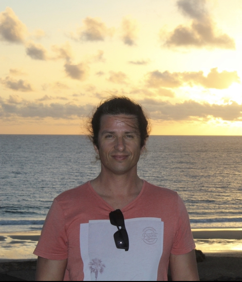 Image of owner of company on the beach at sunset